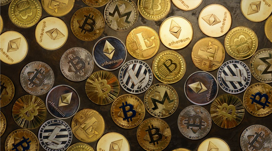 50 Cryptocurrency Coins Spread Out on Table